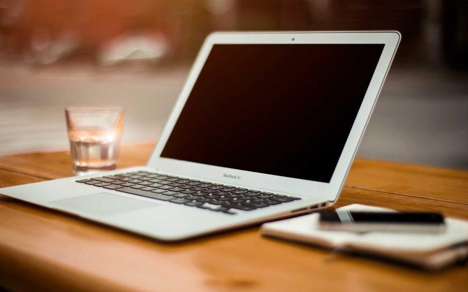 A clean desk with an open laptop